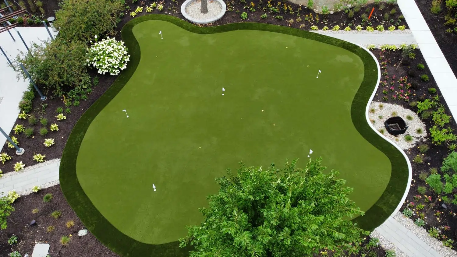Backyard golf green drone shot installed by SYNLawn